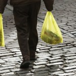 Plastic bags from Marks and Spencer are carried outside a store in London